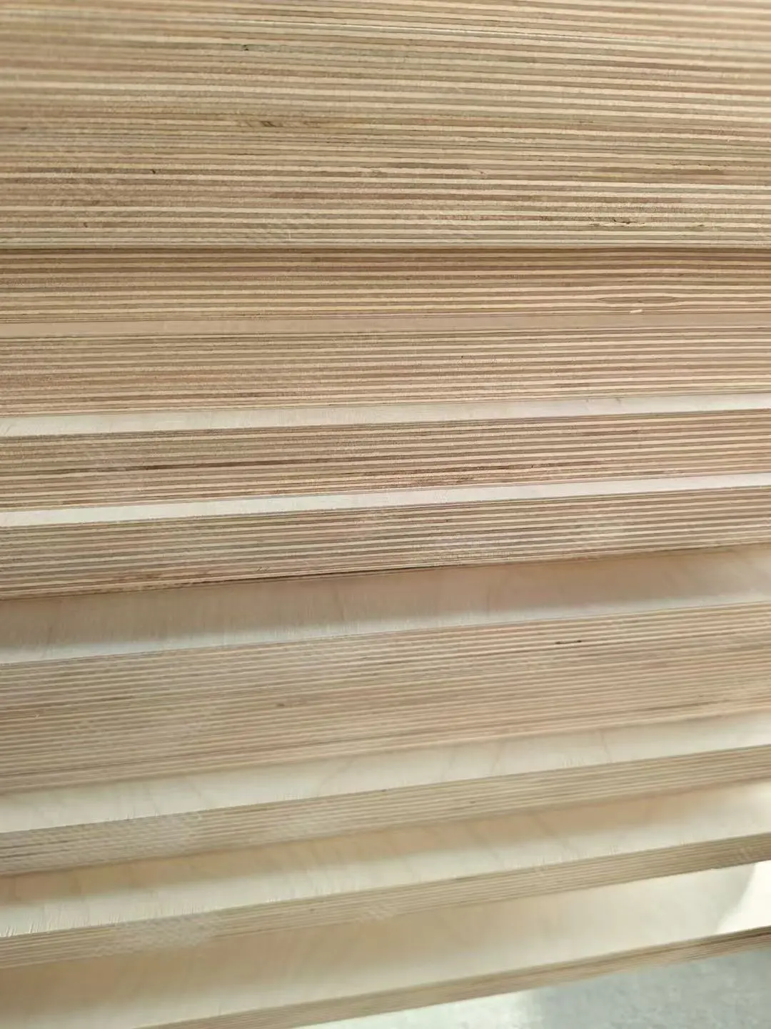 Stacked birch plywood edges showing repeated cross-laminated veneers