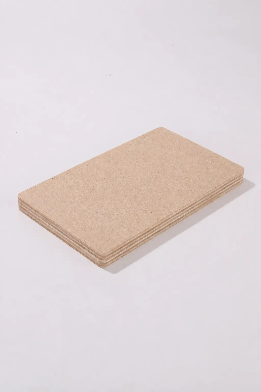 Compact stack of Duraply samples on a neutral background