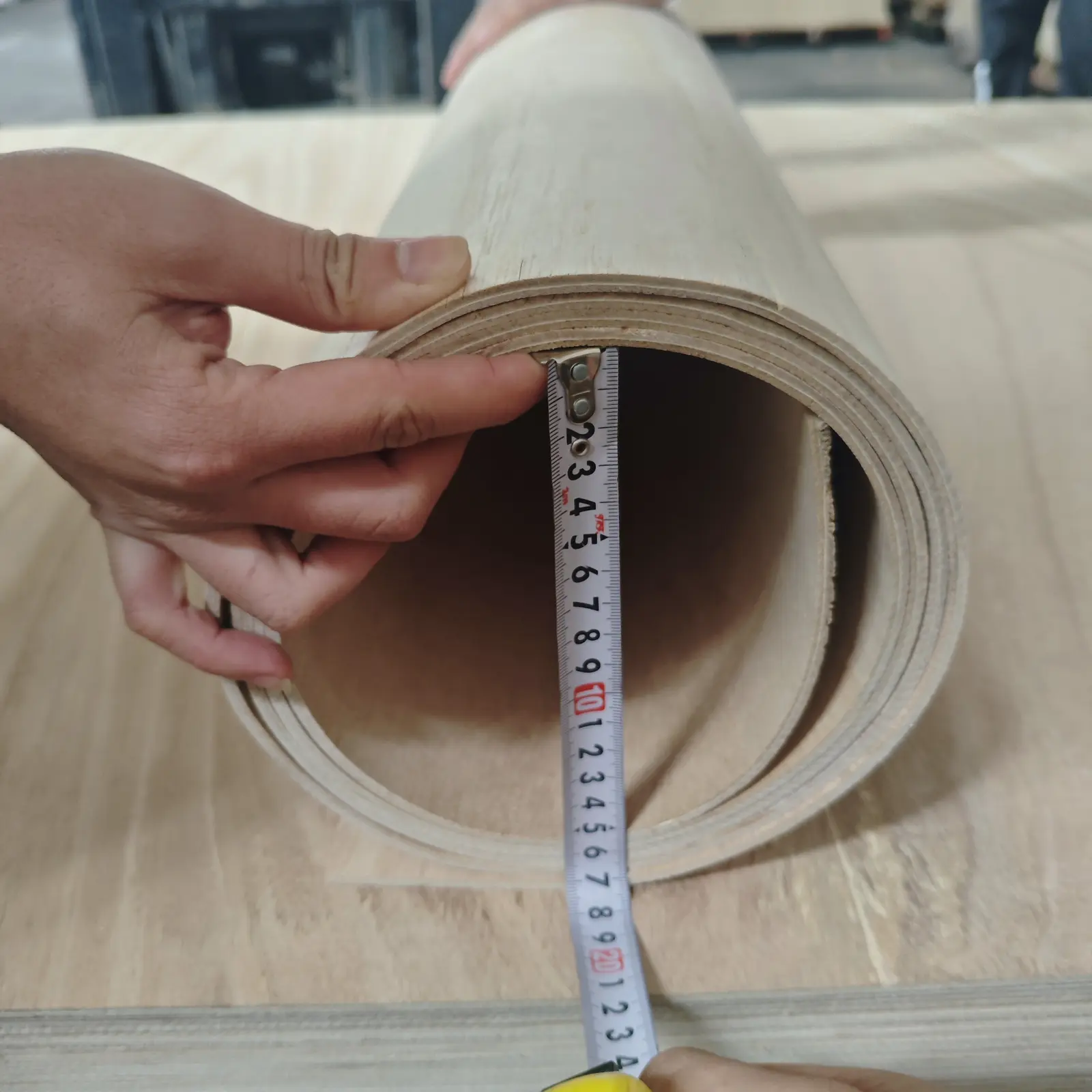 Flexible plywood bend radius being measured
